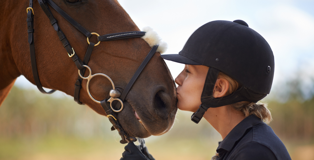 Horse rider kissing their horse