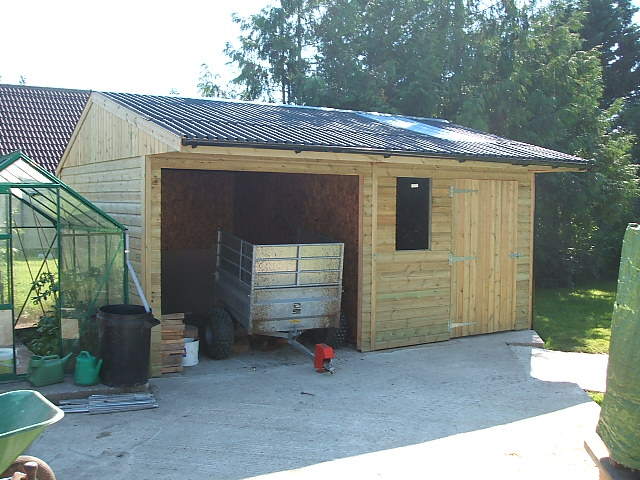 trailer storage attached to wooden garage