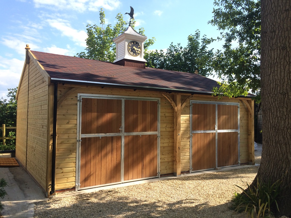 carriage house wooden garage with a clock tower